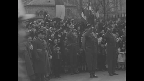 COLMAR - 1945: Packed parade route - Civilians watch troops march past Stock Footage 344005974