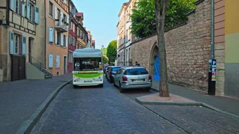 Colmar Town Bus with Tourists driving on cobblestone streets in 4K. Stock Footage 247249853