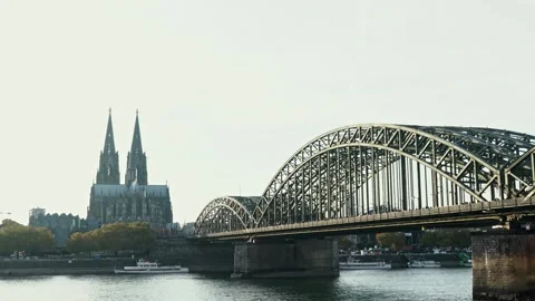 Cologne Cathedral with A bridge spans a river with a city in the background Stock Footage 313416841