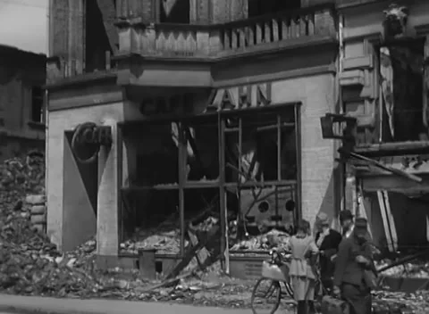 COLOGNE, GERMANY - 1945: Kerb bicycle - gaping windows loom above Stock Footage 344599844