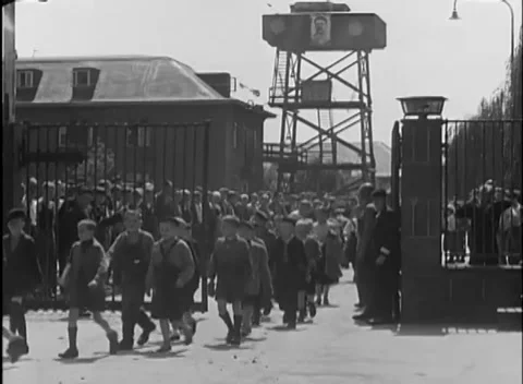 COLOGNE, GERMANY - 1945: Shared walk out - Adults and children carry bundles Vidéo 344599879