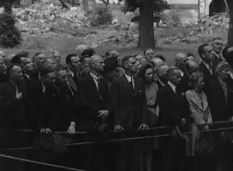COLOGNE, GERMANY - 1945: Tree backdrop - a crowd stands near rubble Stock Footage 344599806