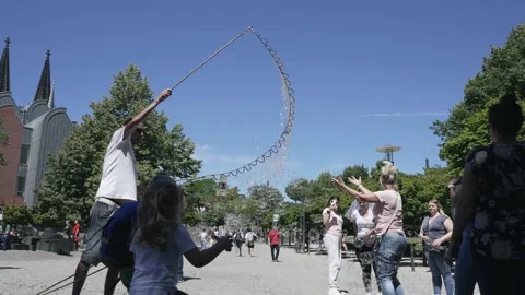 Cologne, Germany - 22 Jun, 2022: Street performer men making giant soap bubbl Stock Footage 218192281