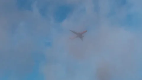 Cologne, Germany - Jan 02, 2024: Passenger plane is flying through a cloudy s Video stock 300310946