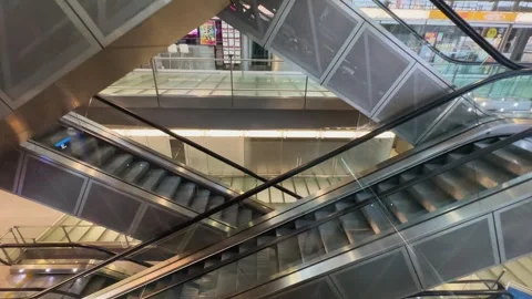 Cologne, Germany - Jul 20, 2023: Moving elevator stairs inside international  Stock Footage 333723695