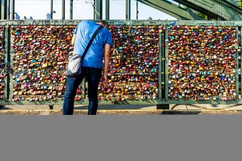 COLOGNE, GERMANY - Jun 18, 2018: A man with a bag over shoulder placing a lov Fotos Stock