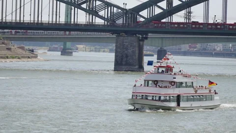 Cologne, Germany - May 02, 2025: Passenger cruise boat sailing under the Hohe Stockbeeldmateriaal 309886545