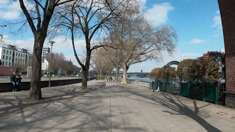 Cologne, Germany - May 10, 2025: Pov walk on sunny walkway along the Rhine ri Stock Footage 320972009