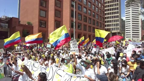 Colombian demonstrators with national flags in protest agaist Ivan Duque gov Stock Footage 153871920