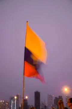 A Colombian flag dances out of focus atop Cafe Del Mar in Cartagena Stock Photos