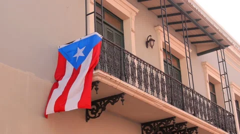 Colonial architecture hispanic balcony with flag in Old San Juan Stock Footage 58761401