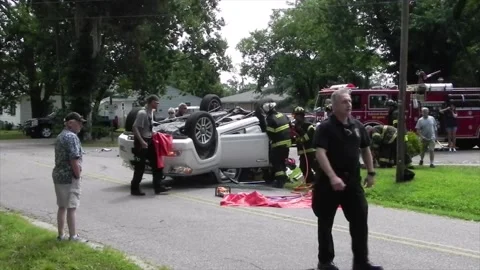Colonial Beach VA US 7-4-2014 Overturned Car Firefighters Remove Passenger Part1 Stock Footage 150377737