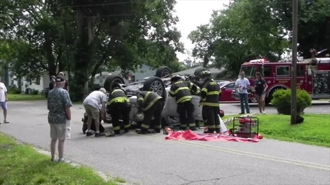 Colonial Beach VA US 7-4-2014 Overturned Car Firefighters Remove Passenger Part2 Stock Footage 150379518