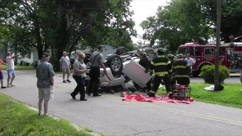 Colonial Beach VA US 7-4-2014 Overturned Car Firefighters Remove Passenger Part3 Stock Footage 150380959