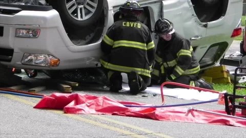 Colonial Beach VA US 7-4-2014 Overturned Car Firefighters Remove Passenger Part5 Stock Footage 150385655