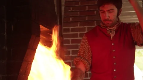 Colonial Blacksmith Working Bellows before pounding Iron - Recreation Stock Footage 105604122