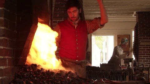 Colonial Blacksmith Working Bellows for Pounding Iron - Recreation Stock Footage 105604232