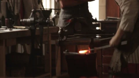 Colonial Blacksmiths Working Bellows, Pounding Iron - Recreation Stock Footage 106673268