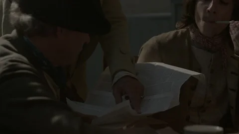 Colonial Man reads Declaration of Independence to others in a 1700s Tavern Stock Footage 90864945