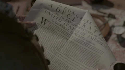 Colonial Man reads document, Declaration of Independence in 1700s Tavern Stock Footage 93699845