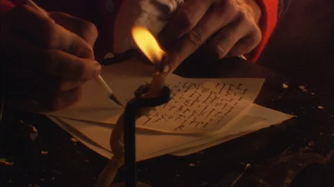 Colonial Man writes with quill at Table by candle light Stock Footage 91354759