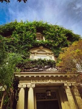 Colonial style building with lonic pediment and lattice stained glass window 스톡 사진