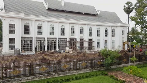 Colonial style building under construction, gate, workers, Vientiane, Laos 스톡 동영상 75557856