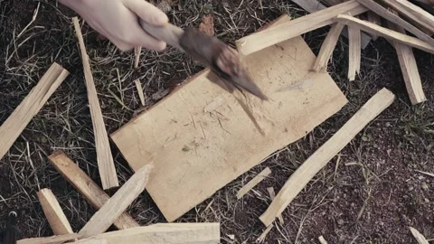 Colony process of oak wood chips to light a fire with a cleaver on the street Stock Footage 147195523