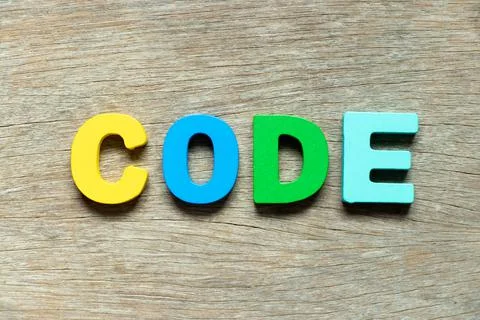 Color alphabet letter in word code on wood background Photos