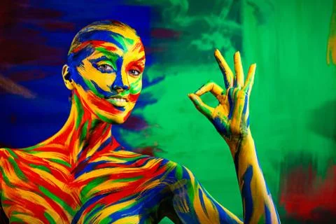 Color art face and body painting on woman for inspiration. Abstract portrait of Stock Photos