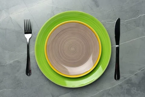 Color ceramic plates on gray background top view Stock Photos