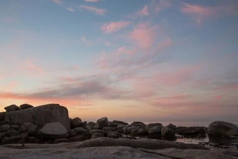 Color cloud formations at sunset over the water Stock Photos
