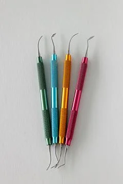Color coded dental composite modeling instruments on white background Stock Photos