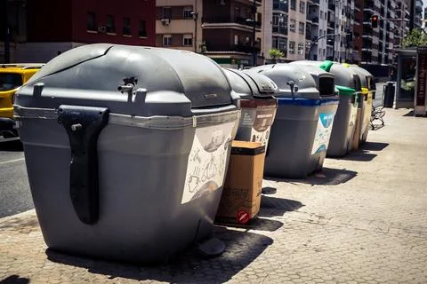 Color-coded recycling containers for urban waste management in Seville. 스톡 사진
