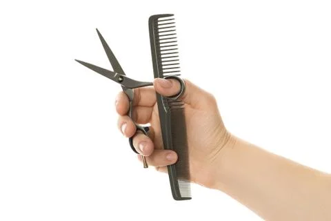 Color comb and scissors in hand Stock Photos