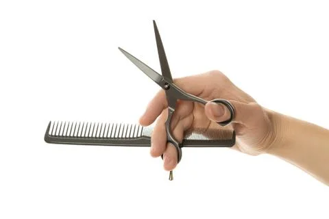 Color comb and scissors in hand Stock Photos