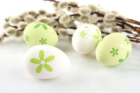 Color easter eggs with catkins on table Stock Photos