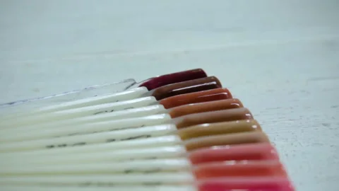 Color examples of nails in the salon manicure Stock Footage 98007153