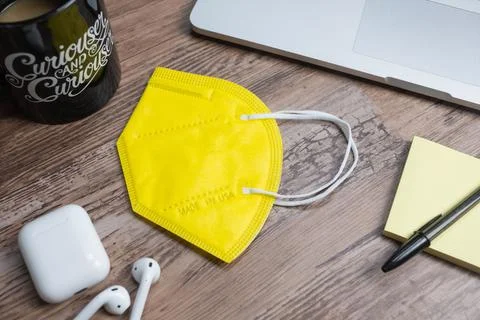 Color facemasks on a desktop with office elements Stock Photos