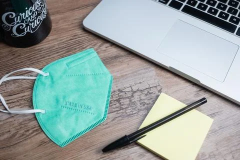 Color facemasks on a desktop with office elements 스톡 사진