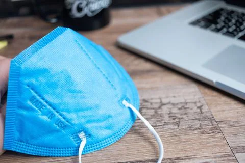 Color facemasks on a desktop with office elements 写真素材