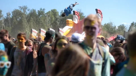 Color fest guy jumping on a trampoline Stock Footage 51552523