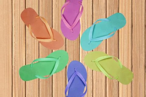 Color flip-flop over wooden texture close-up Photos