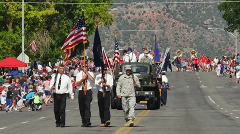 Color guard marches flag small town parade Stock Footage 64890978