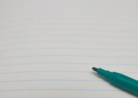 Color marker on white notebook background, close up, copy space. place for te Stock Photos