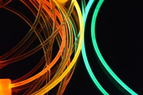 Color motion blurred magic neon red, blue, green, yellow light circles, lines. Stock Illustration