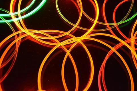 Color motion blurred magic neon red, blue, green, yellow light circles, lines. Stock Illustration