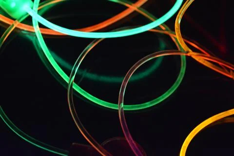 Color motion blurred magic neon red, blue, green, yellow light circles, lines. Stock Illustration