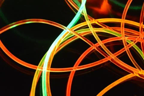 Color motion blurred magic neon red, blue, green, yellow light circles, lines. Stock Illustration