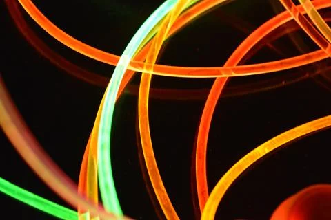 Color motion blurred magic neon red, blue, green, yellow light circles, lines. Stock Illustration